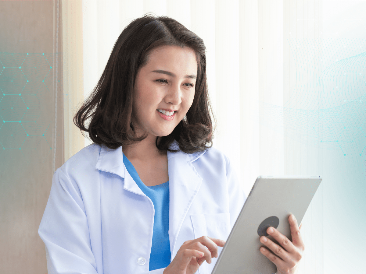 Clinician holding a mobile device while analyzing medical data.